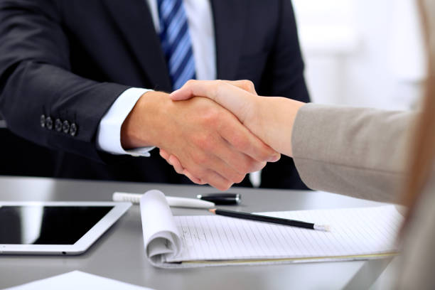 business people shaking hands, finishing up a meeting.